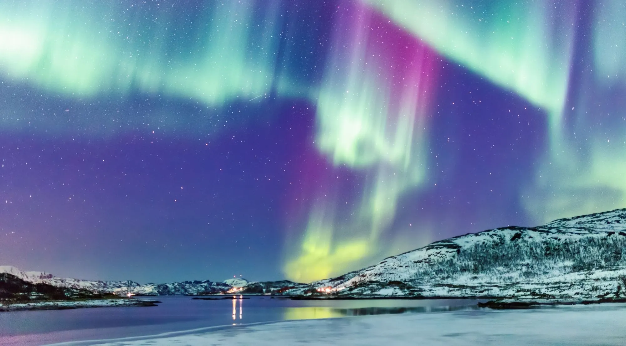 Northern Lights over a frozen lake in Finnish Lapland